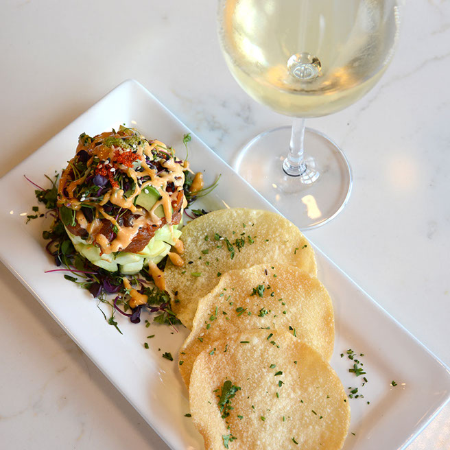 Women enjoying food on the rooftop patio of No Name Saloon & Grill
